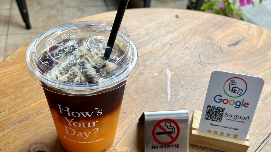 テーブルに置かれた、So good coffee & smoothieのオレンジコーヒー