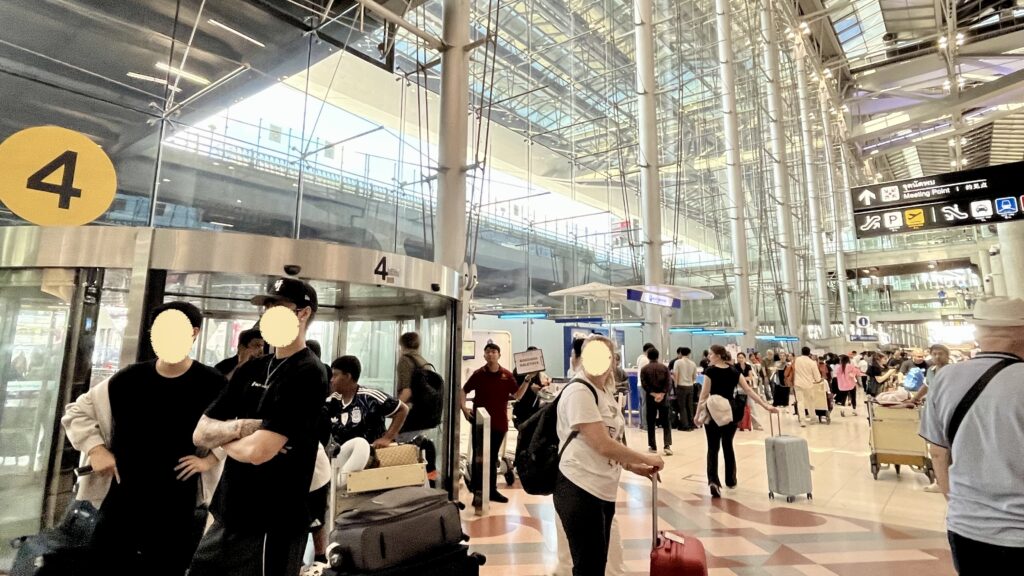 スワンナプーム国際空港到着ロビーの4番出口のピックアップポイント、多くの観光客がいる